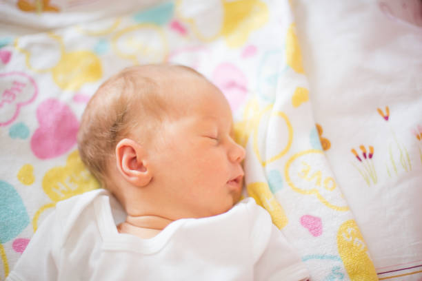 istock cute newborn baby sleeping peacefully in the crib 655999516