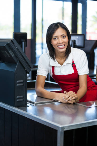 istock Female staff sitting at cash counter 656005736