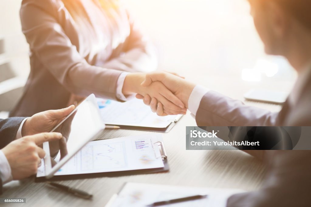 Business people shaking hands, finishing up meeting Business people shaking hands, finishing up a meeting Business Stock Photo