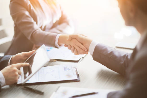 Business people shaking hands, finishing up meeting stock photo