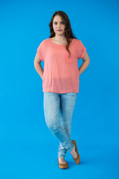 istock Beautiful woman standing against blue background 656009234