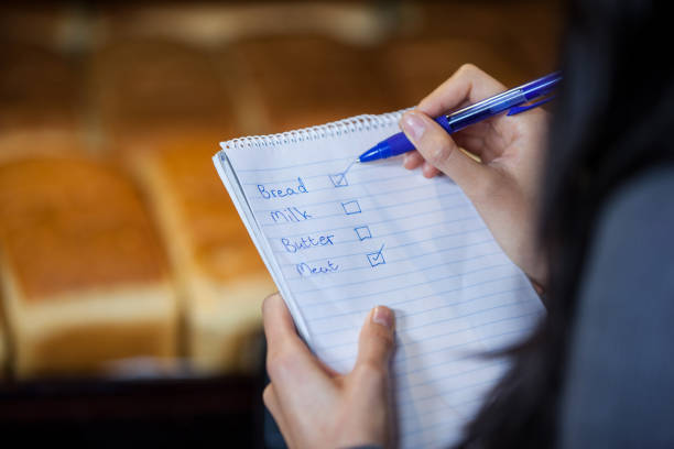istock Mid section of woman marking on checklist 656019330
