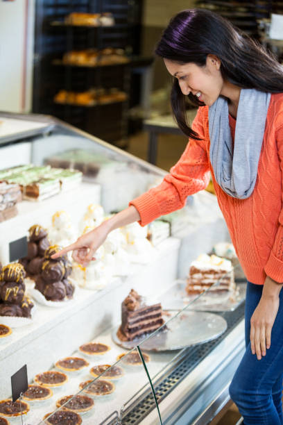 istock Happy woman selecting desserts 656019440