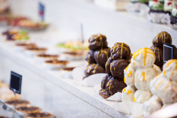 Chocolate Cream Profiteroles Displayed in Pastry Case