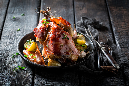 Grilled pheasant with bacon and spices and vegetables