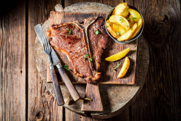istock Delicious tbone steak and chips on the black rock 656022266
