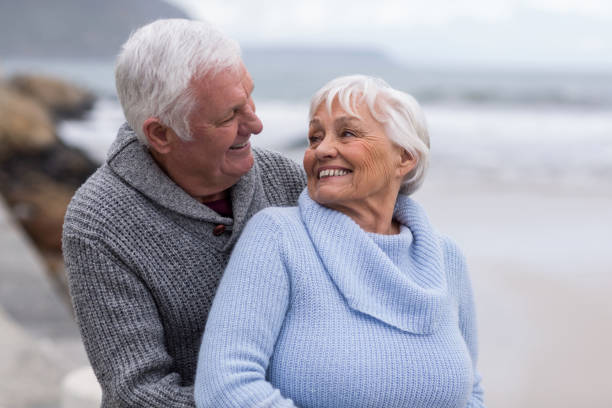 istock Senior couple embracing each other on the beach 656023320