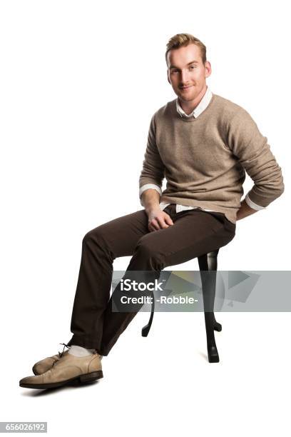 Attractive Man Smiling Wearing Sweater Stock Photo - Download Image Now - Sitting, Men, Chair