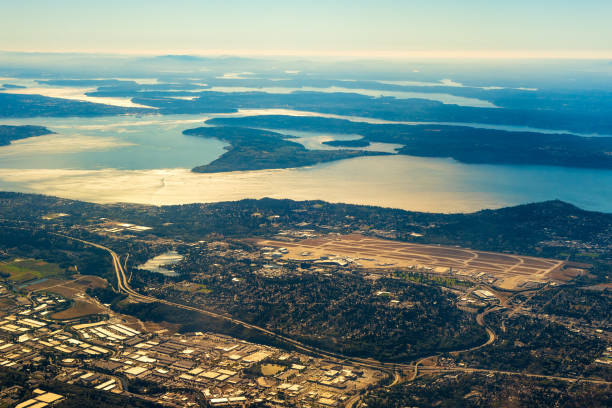 Seattle airport Seattle-Tacoma International Airport from the air with the southern end of Puget Sound in late afternoon light tacoma photos stock pictures, royalty-free photos & images