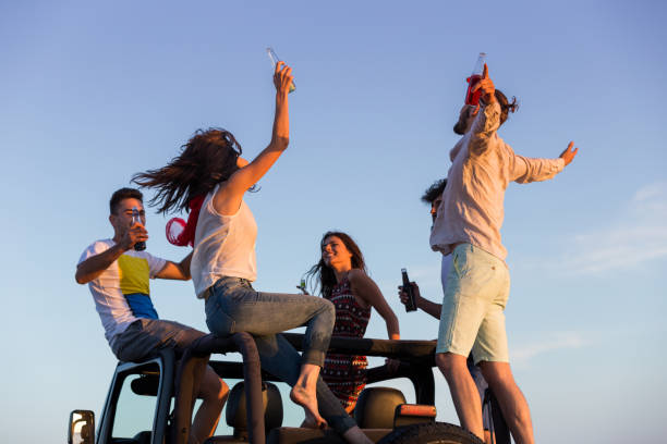 istock young group having fun on the beach and dancing in a convertible car 656036038