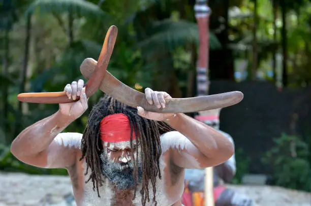 Yugambeh Aboriginal man holds boomerangs during Aboriginal culture show in Queensland, Australia.