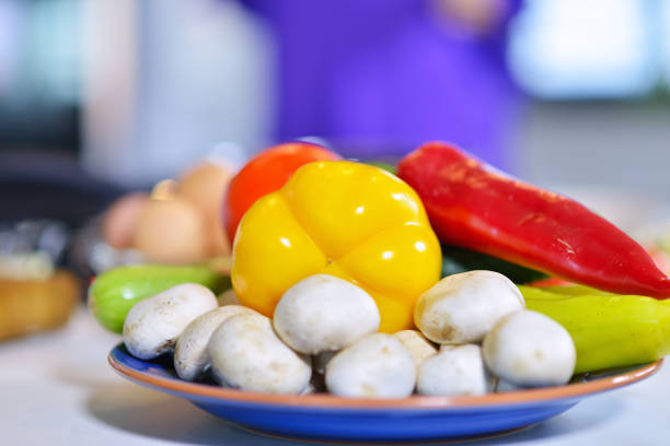 Fresh Vegetables on the Table in the Kitchen, Highlighting the Concept of Home-Grown Produce. The Scene Showcases a Variety of Vegetables Harvested from a Home Garden, Emphasizing the Natural and Healthy Qualities of Home-Grown Food. The Bright and Inviting Kitchen Setting Enhances the Focus on Nutritious, Locally-Sourced Ingredients.