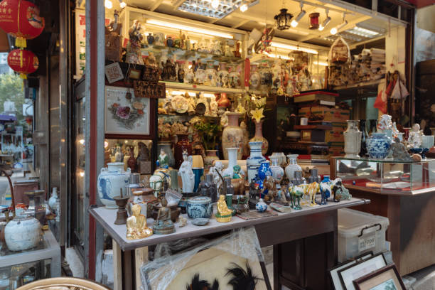 Antique Shop in Cat Street in Hong Kong, Hong Kong, Hong Kong S.A.R. - January 26, 2017: Antique Shops in Cat Street in Hong Kong. Hollywood Road, Upper Lascar Row aka Cat Street is a major tourist attraction in Hong Kong. antique chinese dolls pictures stock pictures, royalty-free photos & images