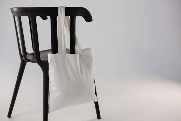 istock White bag hanging on a black chair 656040212