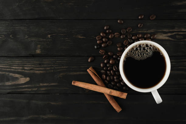 istock coffee cup and cinnamon on black wood. 656048048