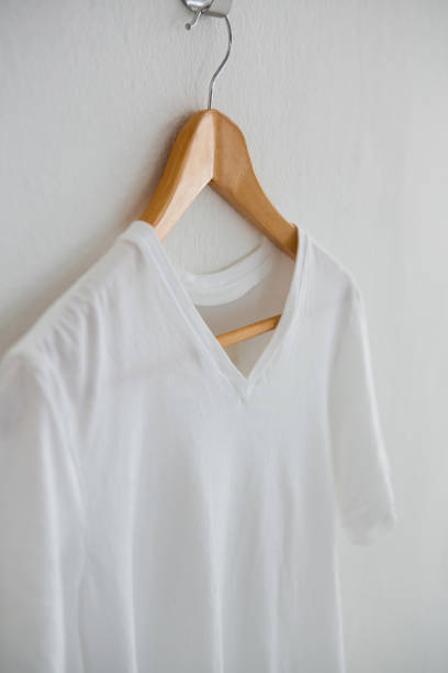 istock White t-shirt hanging on hanger 656057398