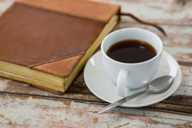 istock Cup of coffee with organiser on wooden table 656057756