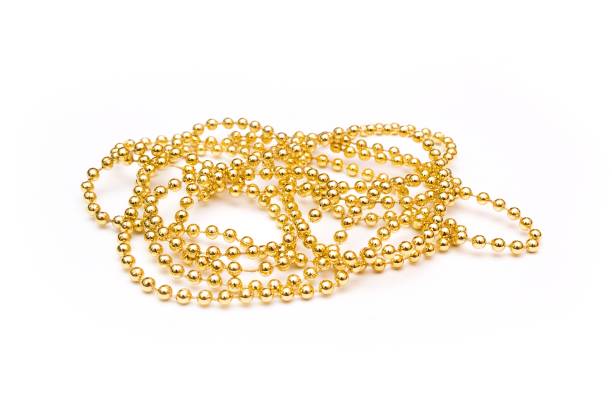istock Golden beads isolated. Golden shine. Yellow background 656058554