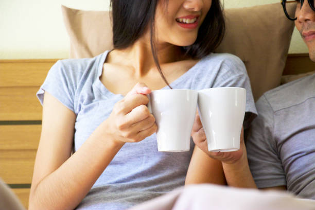 istock Woman is having coffee with boyfriend in bed. 656064924