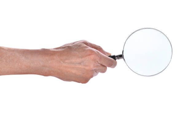 istock man hand holding magnifying glass isolated on white background 656067426