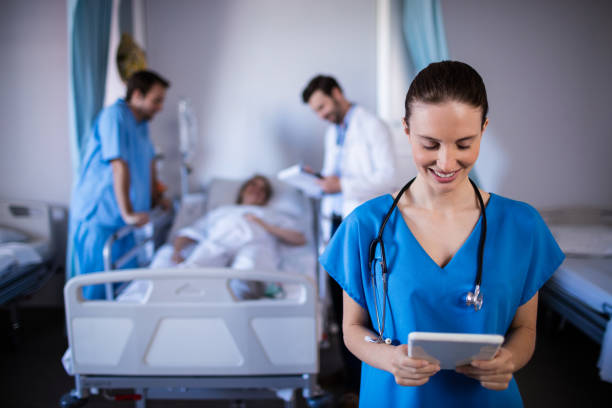 istock Smiling female doctor using digital tablet in ward 656068386