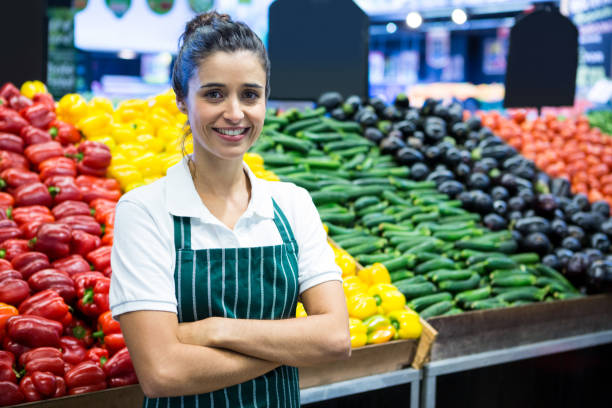 istock Female staff standing with arm crossed in organic section 656070932