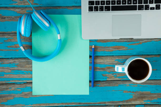 istock Laptop, headphones and coffee on wooden table 656073136
