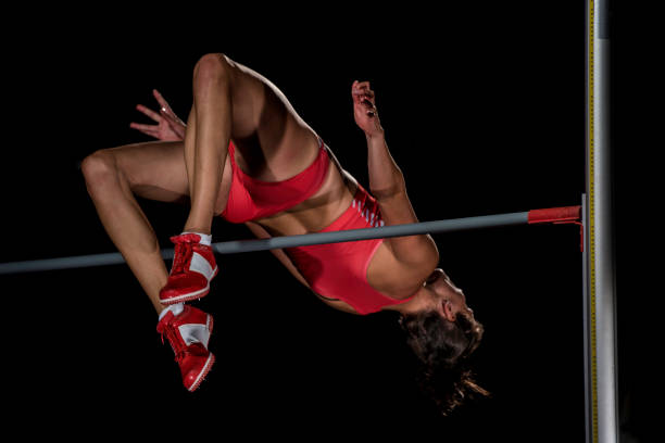 istock Woman in mid-air jumping over a horizontal bar 656078080