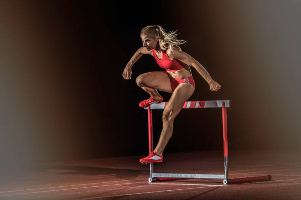 istock Female athlete clearing a hurdle 656078364