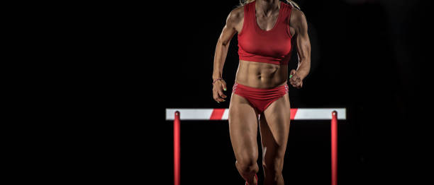 istock Female athlete running away from a hurdle 656078390