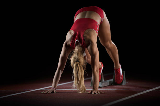 istock Female athlete preparing at starting line 656078590