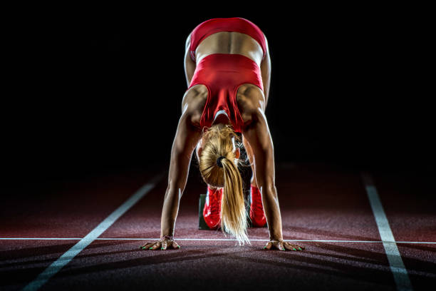 istock Female athlete preparing at starting line 656078696