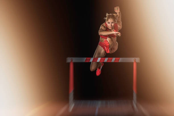 istock Female athlete jumping over a hurdle 656078792