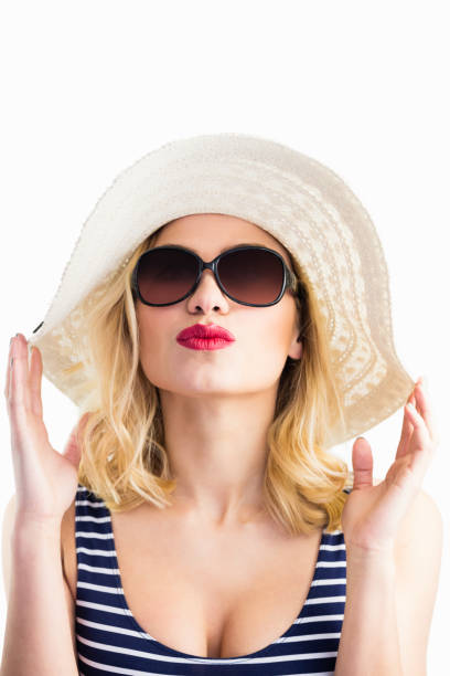 istock Beautiful woman posing with hat against white background 656079072
