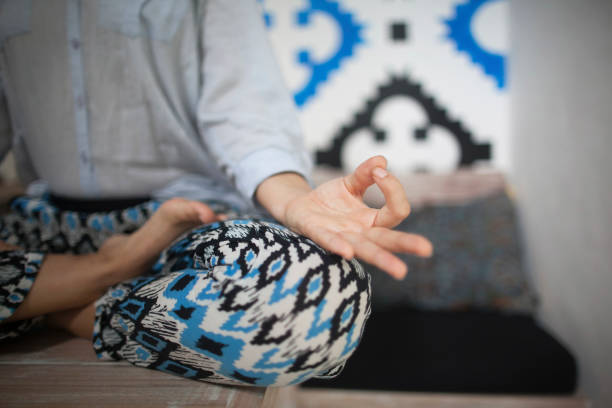 istock young smiley woman doing yoga in home 656081890