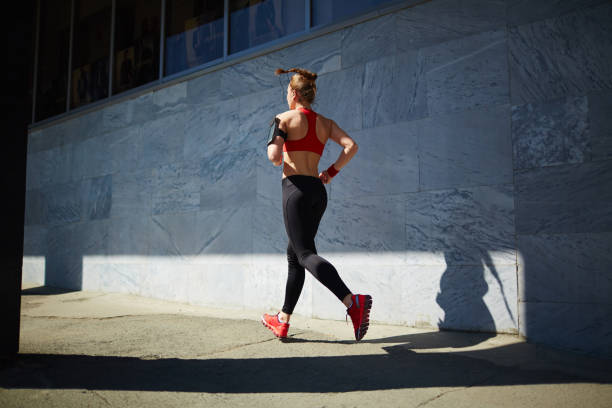 istock Girl jogging in downtown 656083054