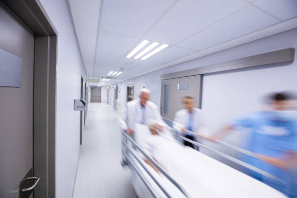 istock Doctors and nurse pushing emergency stretcher bed in corridor 656086556