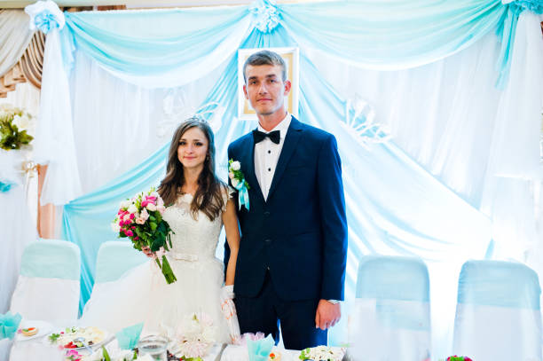 istock Wedding couple stay near table at restaurant 656089938