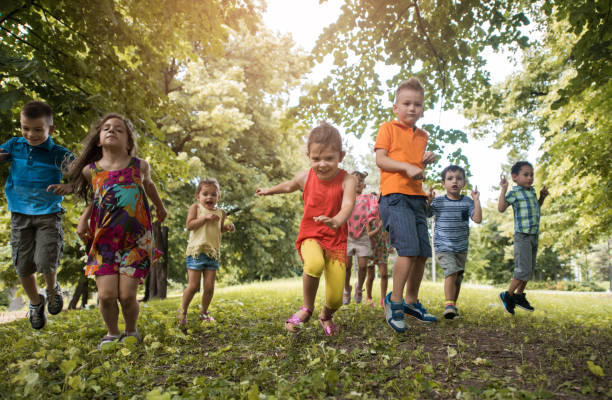 istock Group of carefree kids having fun while jumping in nature. 656092940