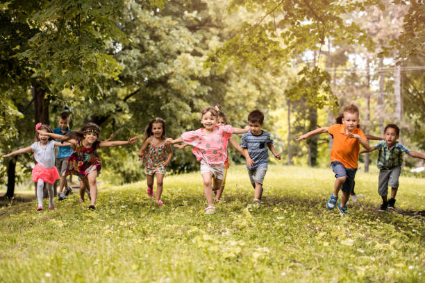 istock Group of playful children having fun while running in nature. 656092942