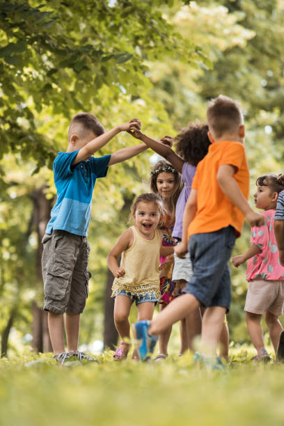 Group of small kids having fun while playing in nature.