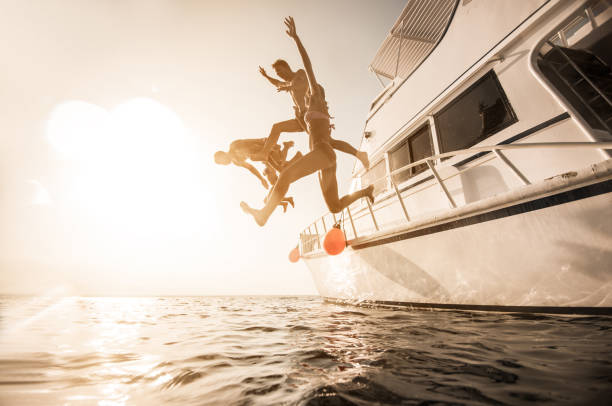 istock Playful people jumping from the boat into the sea. 656093916