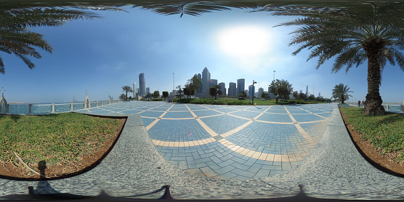 360 degrees spherical panorama of the abu dhabi corniche with view of the skyline an blue water an palm trees (UAE)