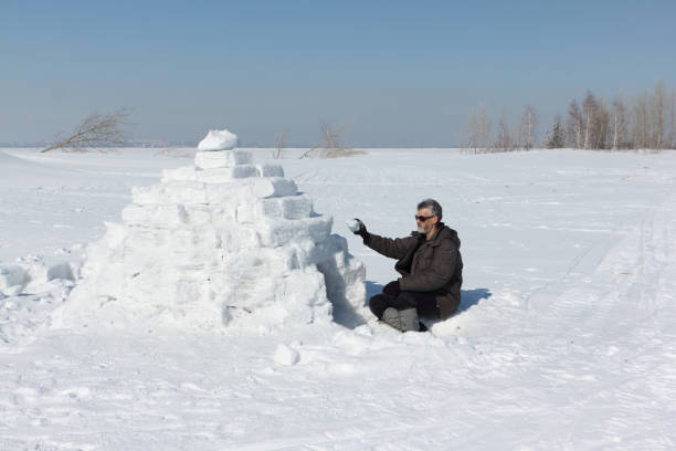 istock Man building an igloo on a glade in the winter 656104926