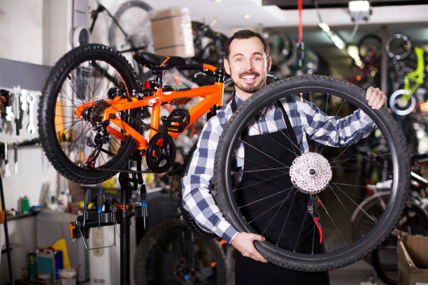 istock man in apron considering composition of wheel for bicycle 656112404