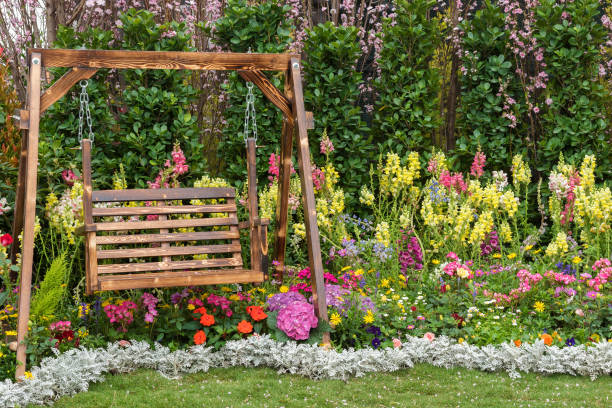 seat in flower garden Wooden swing seat in flower garden wooden porch stock pictures, royalty-free photos & images