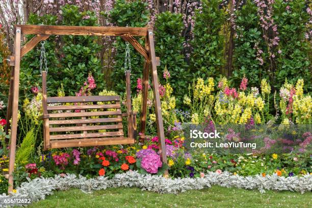 Seat In Flower Garden Stock Photo - Download Image Now - Yard - Grounds, Swing - Play Equipment, Flower