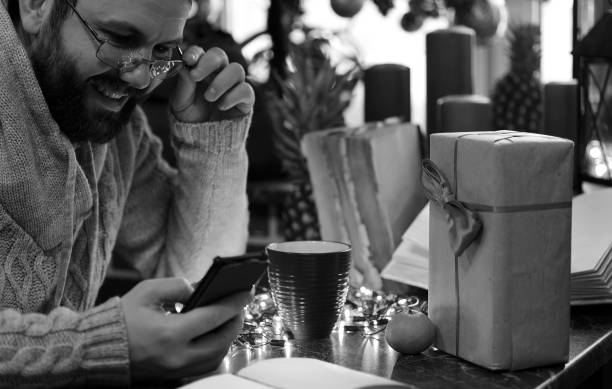 istock monochrome beard man writing christmas gifts on a table 656115920