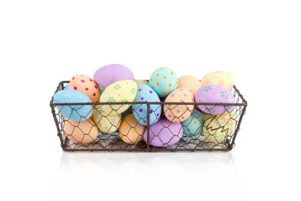 Cut out of hand-painted eggs in a chicken wire tray