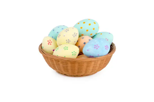 Cut out of colorful easter eggs in a wicker bowl